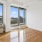 Living space with large windows and a door open to a terrace
